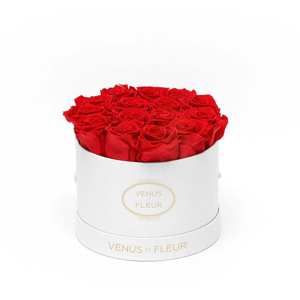 Round white box with about 14 red roses inside, labeled 'VENUS ET FLEUR'