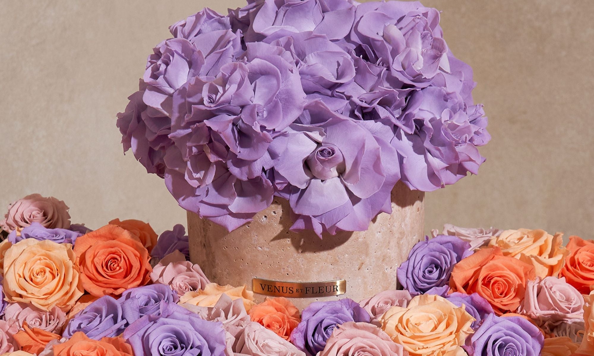 A Terre Travertine Stone Vase Among Spring Roses
