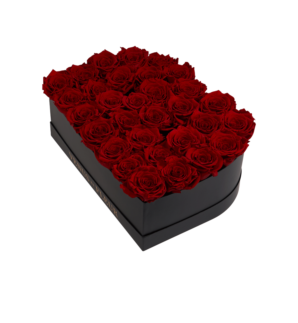 Black rectangular box filled with 28 red roses, with the text 'VENUS ET FLEUR' on the side of the box.