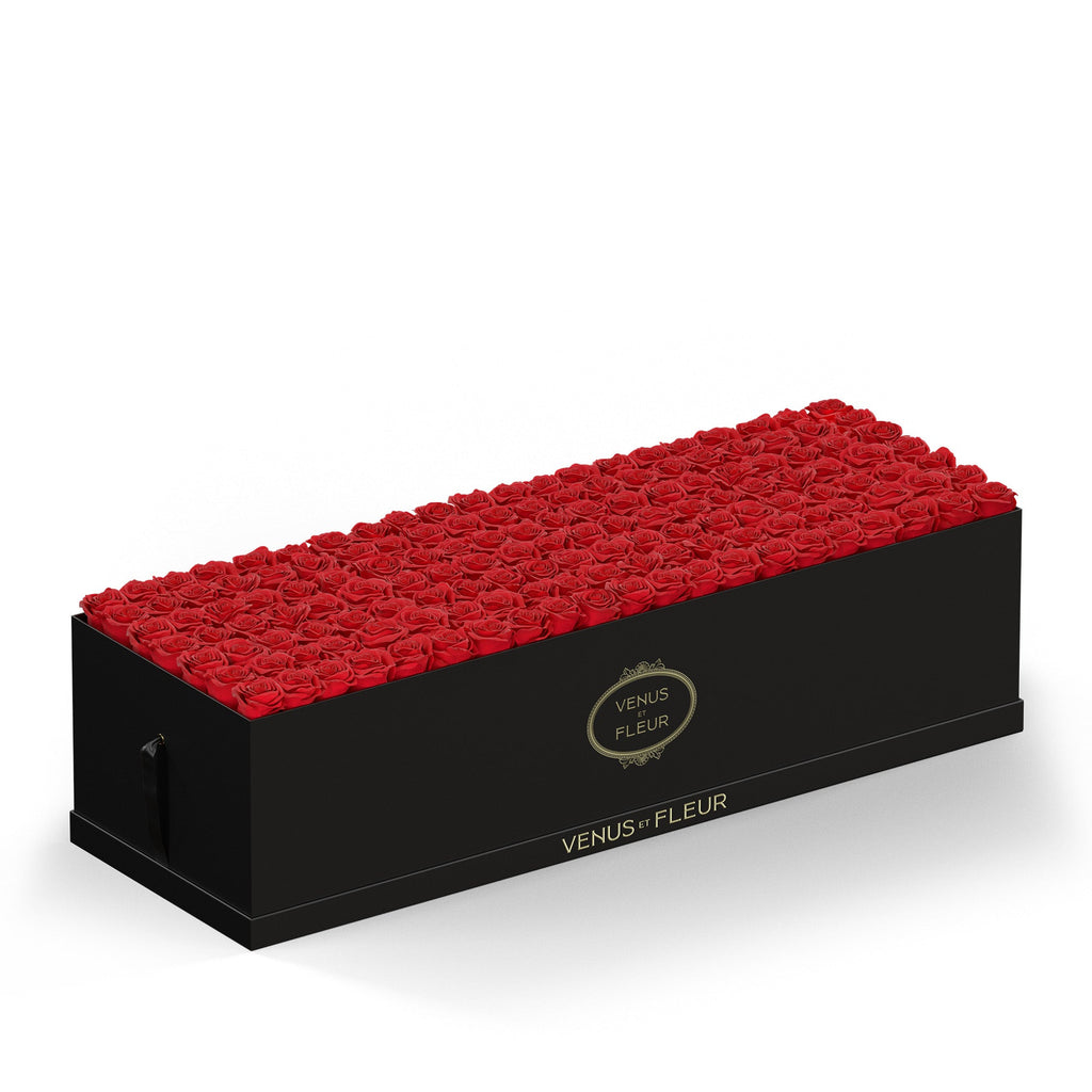 Rectangular black box filled with red roses, branded with 'VENUS ET FLEUR' in gold lettering