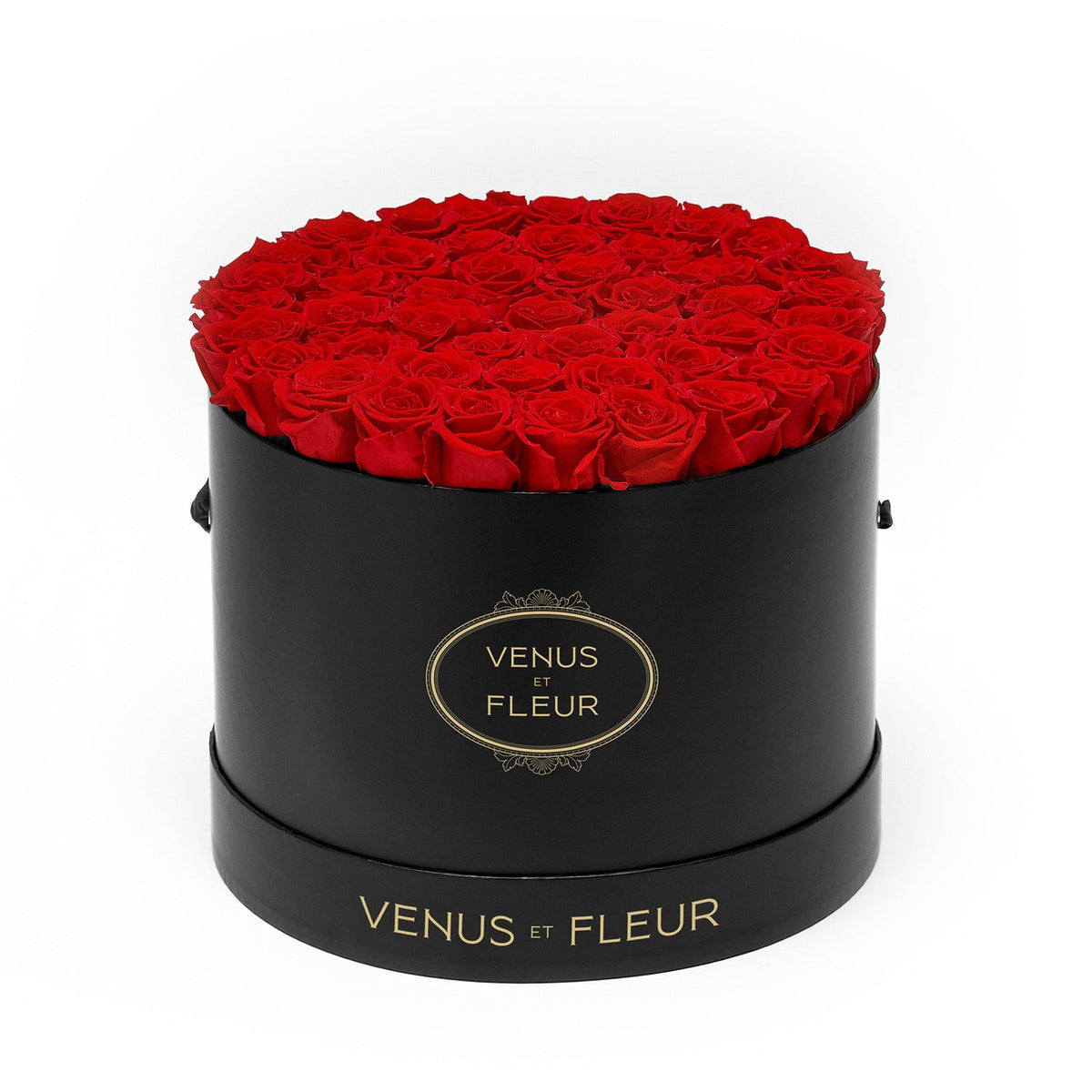 Black round box filled with red roses, labeled 'VENUS ET FLEUR'
