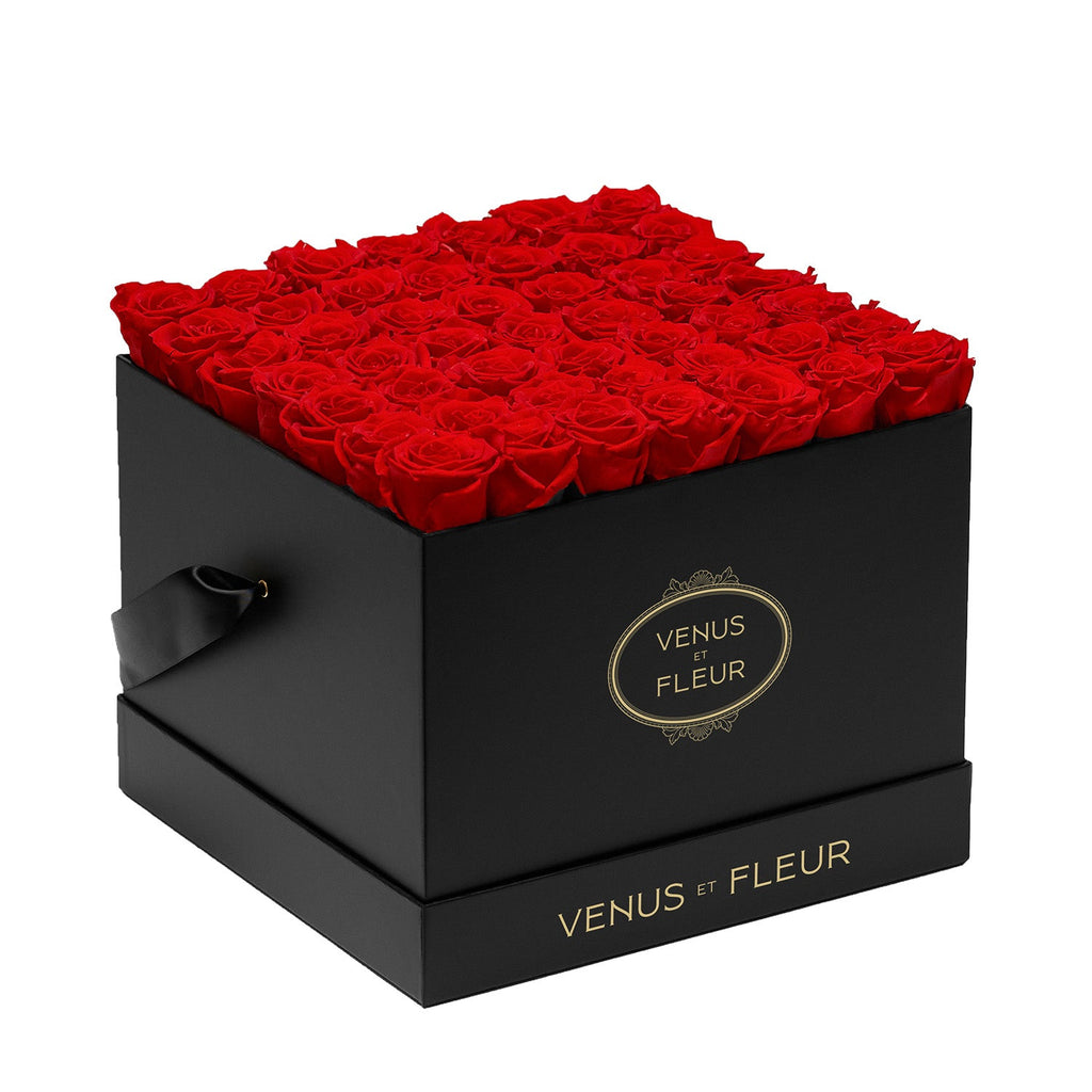Black square box filled with red roses, branded with 'VENUS ET FLEUR' on the front and bottom edges.