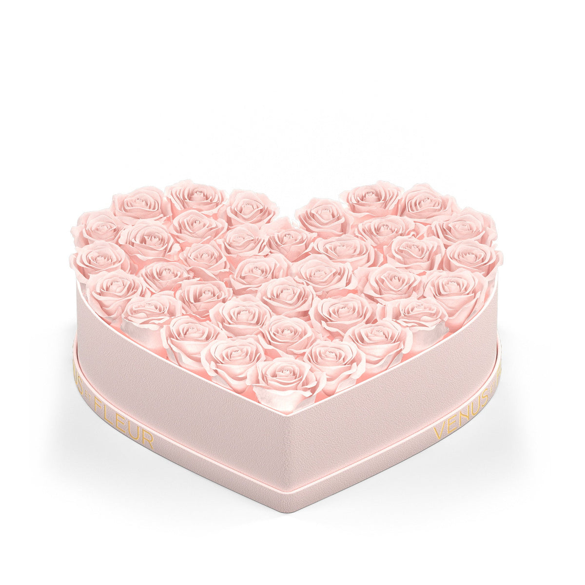 Heart-shaped pink box filled with light pink roses, with gold text 