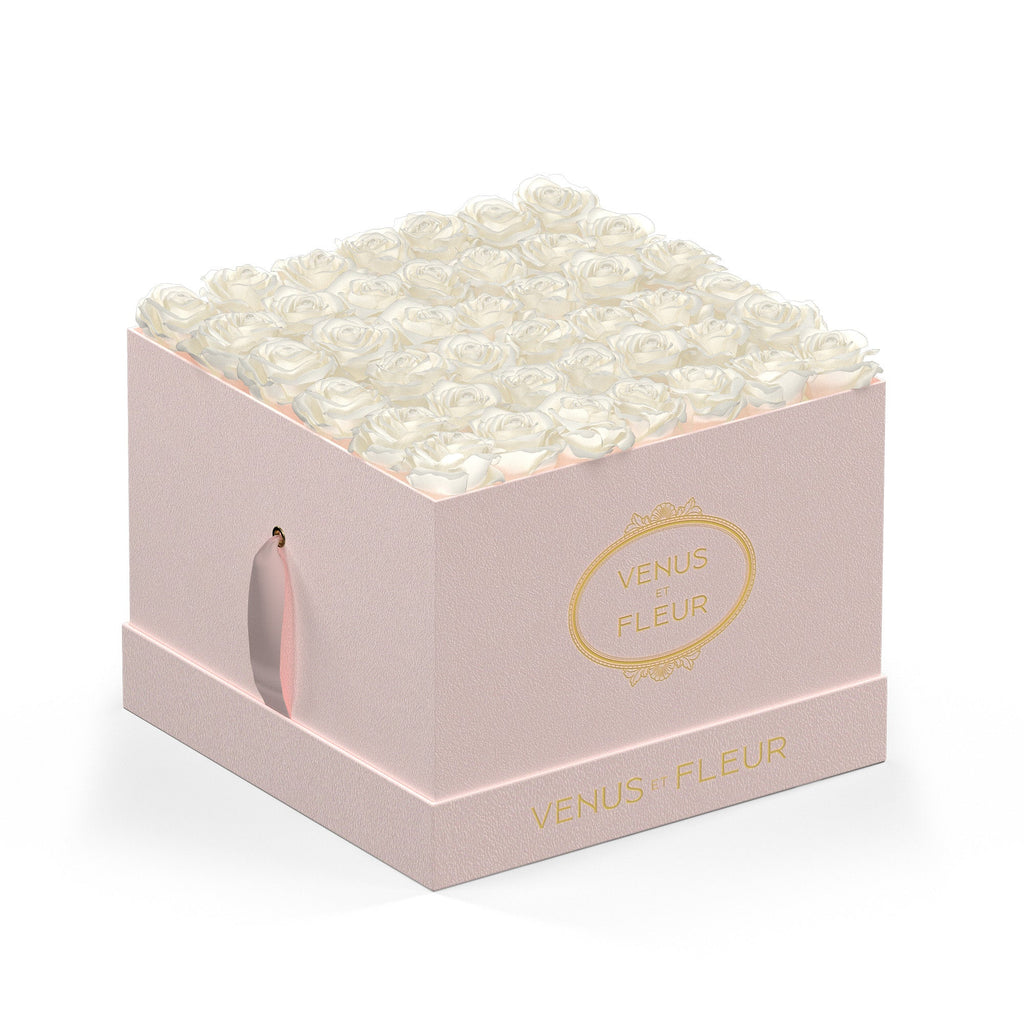 Pink square box filled with white roses, labeled 'VENUS ET FLEUR'