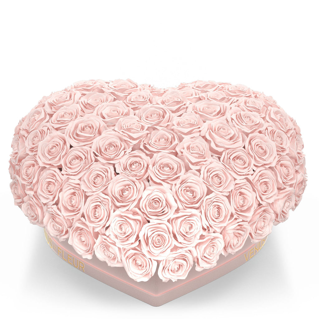 Heart-shaped box filled with pale pink roses from Venus ET Fleur