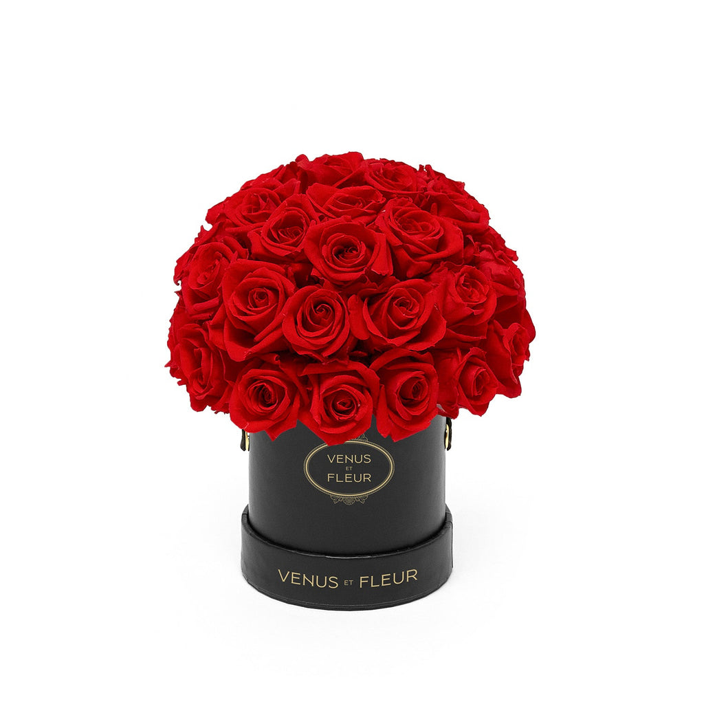 Black round box with red roses and gold text 'VENUS ET FLEUR' on the box