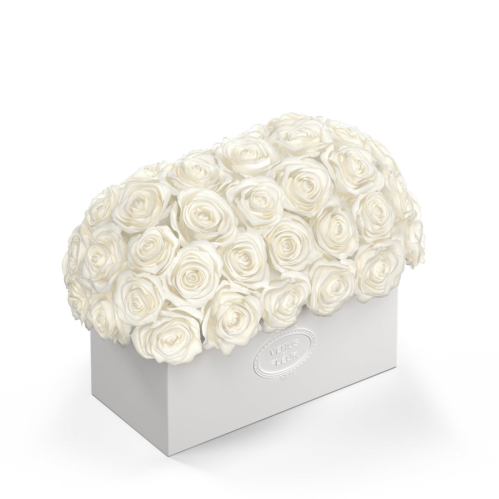 White rectangular box filled with white roses, embossed with the text 'VENUS ET FLEUR'
