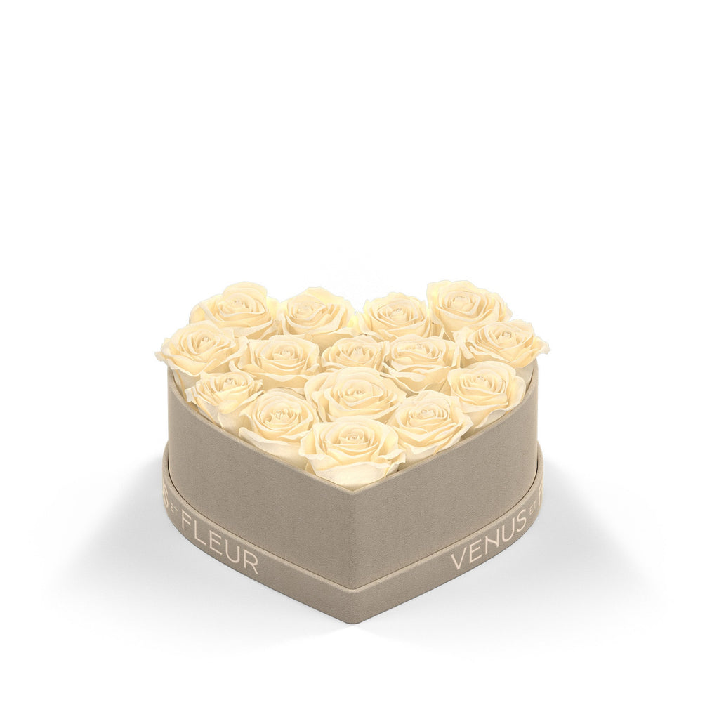 Heart-shaped box with cream-colored roses and the text 'VENUS ET FLEUR' on the side of the box.