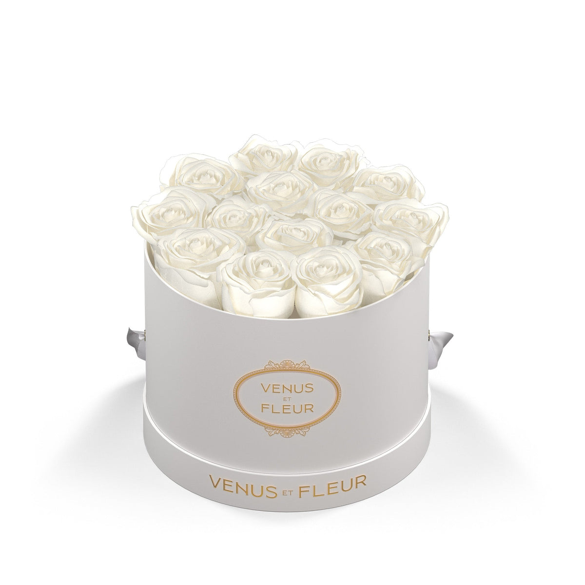 Round white box of white roses with the text 'VENUS ET FLEUR' on the box