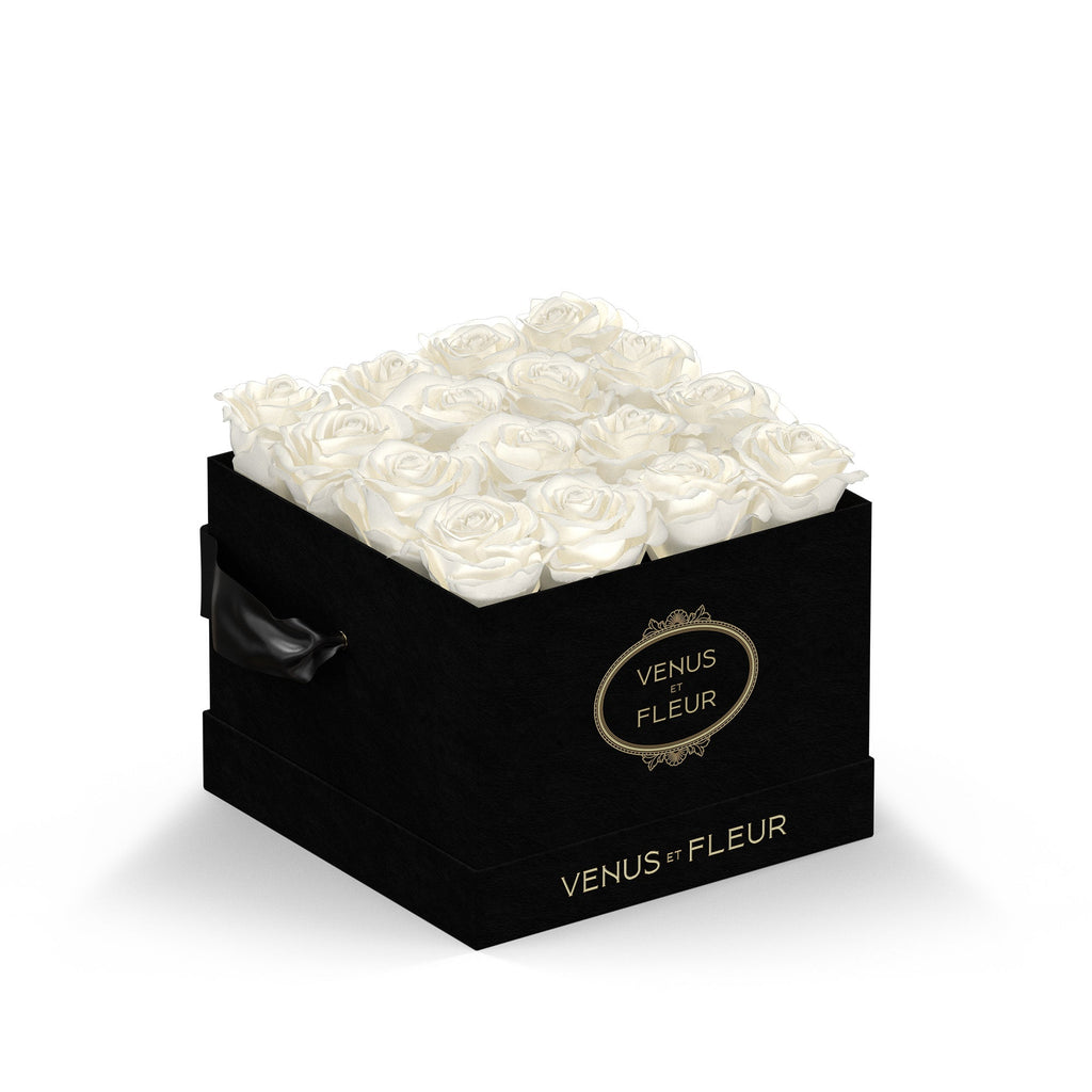 Black square box filled with white roses, labeled "VENUS ET FLEUR" on the front and side.