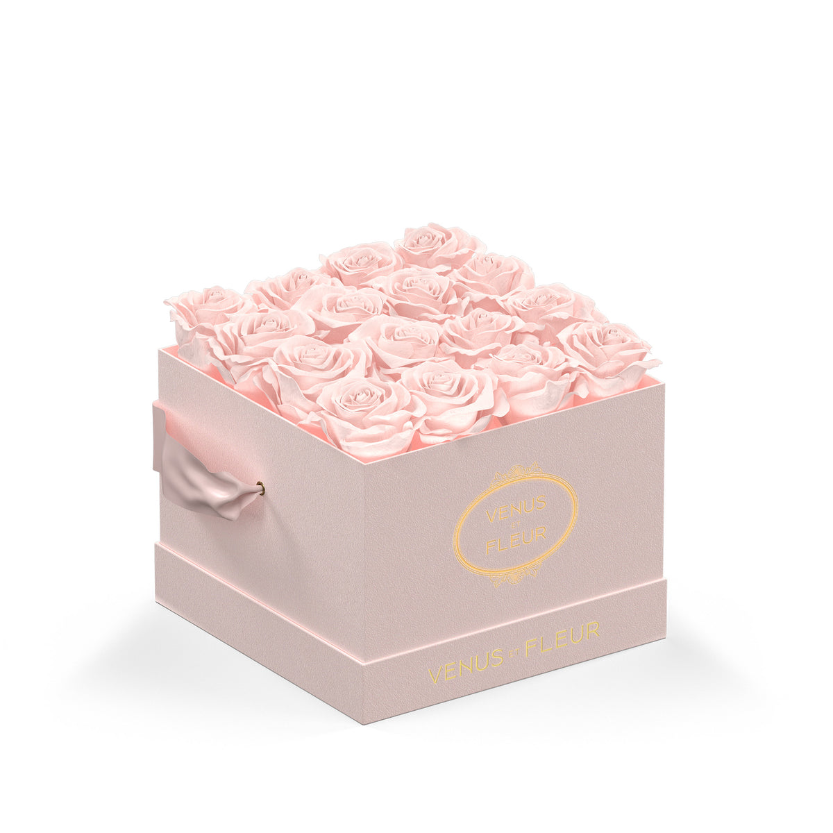 Pink square box filled with pink roses, with the text 'VENUS ET FLEUR' visible on the front and side of the box.