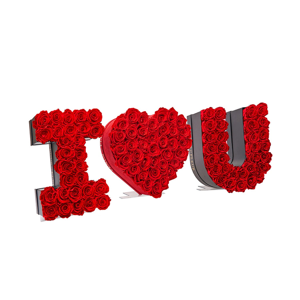 Floral arrangement spelling 'I heart U' made of red roses