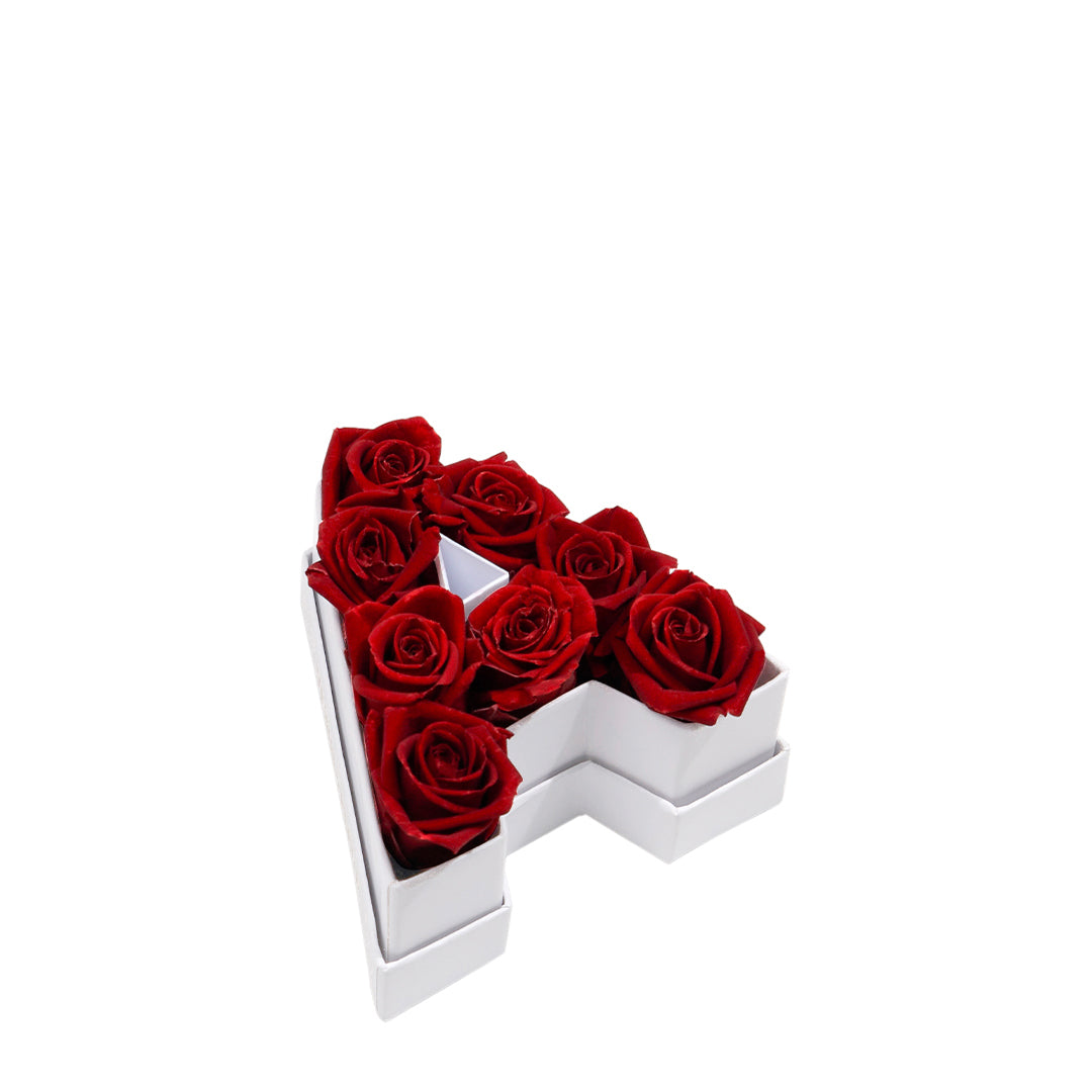 White box shaped like the letter A filled with seven red roses