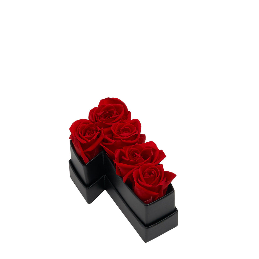 Black container shaped like the number 1 holding five red roses.